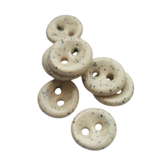 a pile of milky-gray loose buttons